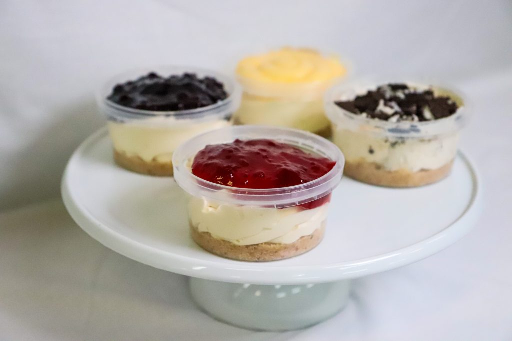 Individual cheesecake Cup topped with strawberry compete
