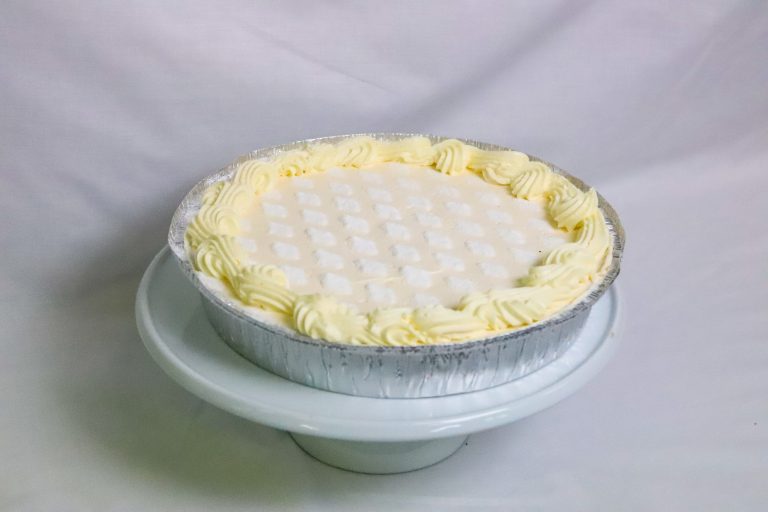 Fresh Chilled Vanilla Cheesecake topped with icing sugar and fresh cream