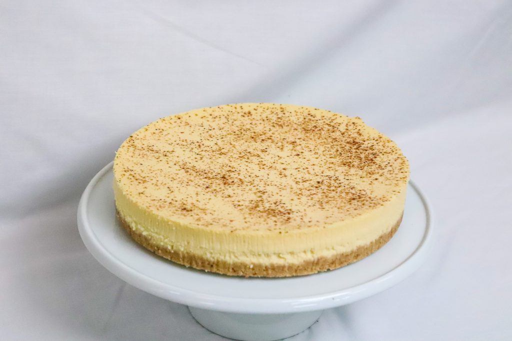 Fresh Baked american Cheesecake topped with a dusting of cinnamon