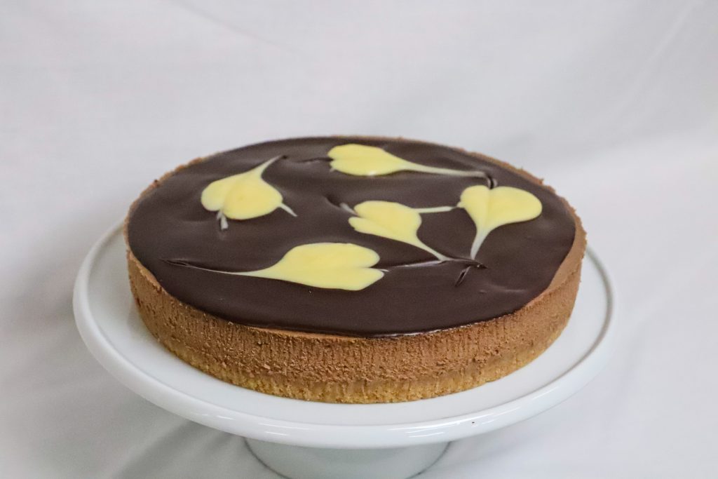 Baked Chocolate Cheesecake topped with both chocolate and white chocolate ganache