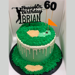 green and white drip birthday cake with piped golf theme and Happy Birthday topper