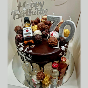 Chocolate drip 70th birthday cake topped with chocolates and alcohol