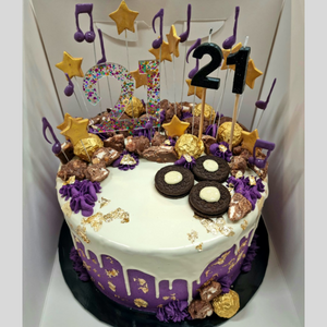 purple and white chocolate drip cake with music theme