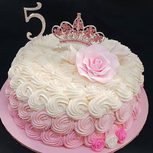 rosette decorated sponge cake with tiara and rose topper