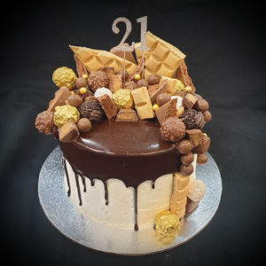 choc drip mudcake topped with chocolates and 21 cake topper