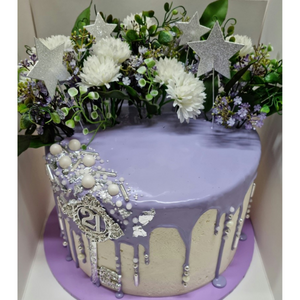 purple drip cake with pearls and silver sprinkles