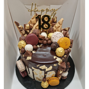 18th birthday drip cake topped with chocolates and macarons