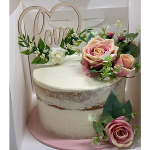 wedding cake with love topper and pink roses