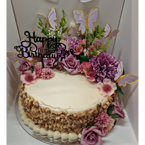 carrot cake with purple flowers and butterflies