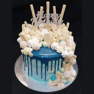 blue drip cake with white toppers