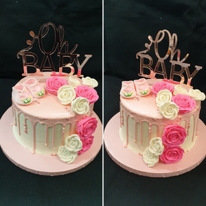 baby shower cake with pink drip and white and pink roses