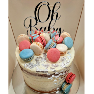 Naked baby shower stacked cake topped with macaroons and an Oh Baby topper