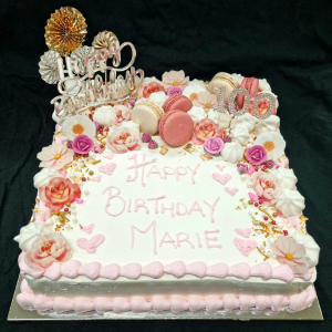 slab cake decorated with florals and macarons for 100th birthday celebration
