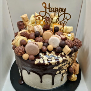 stacked drip mudcake with gold leaf and assorted chocolates