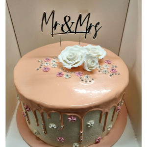 stacked mudcake with peach drip and peach cake board. topped with edible roses cachous and a MR and Mrs cake topper